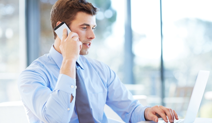 person at desk using mobile phone